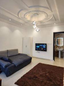 a bedroom with a bed and a flat screen tv at قصر الهدوء in Jeddah