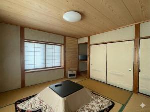 a room with a bed and a large window at Mizubaso in Gujo