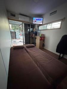 a large bed in a room with a television at My Ideal in Balneario Argentino