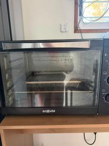 a toaster oven sitting on a wooden table at My Ideal in Balneario Argentino