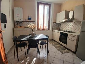 a kitchen with a table and chairs in a room at Marruvium 1937 in Avezzano