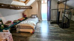 a bedroom with a bed and a stair case at La p'tite maison in Blacy