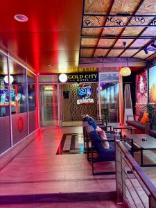 a restaurant with red lighting and tables and chairs at Gold City Hotel by Erebara in Debar
