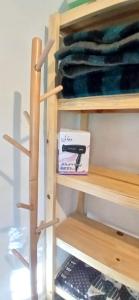 a wooden shelf in a closet with a pen on it at Pacha Wasi in Humahuaca