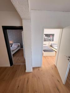 a room with two beds and a mirror at Wohnung in herzogenrath-strass für max 4 Gäste in Herzogenrath