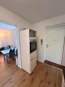 a kitchen with a refrigerator and a table in a room at Wohnung in herzogenrath-strass für max 4 Gäste in Herzogenrath +5 photos