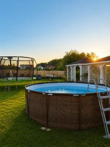 a pool in a yard with a swing at Sunrise Marina Domki Mielno- Ferienhaus in Mielenko