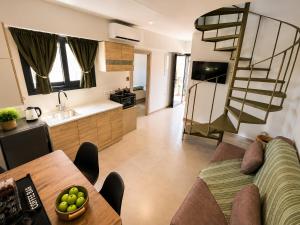 a kitchen and living room with a couch and a table at Sea Salt Maisonettes Samos in Ireon