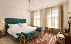 a bedroom with a large bed and a blue couch at Athenian Vintage Apartments in Athens +150 photos