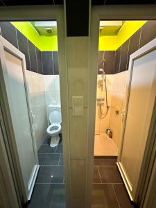 a bathroom with a toilet and a shower with yellow ceilings at Halal Una Royal in Ivišovo Greblje
