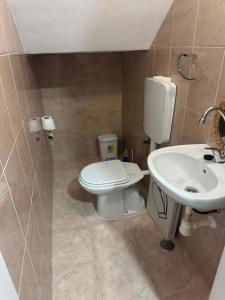 a bathroom with a toilet and a sink at S Vicente Live in Mindelo +11 photos