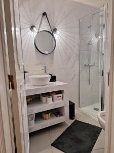a bathroom with a sink and a shower with a mirror at Casa 3 Chamines in Vila Alva +15 photos