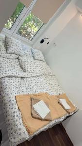 a bed in a small room with windows at Rebeka Vendégház in Dunasziget