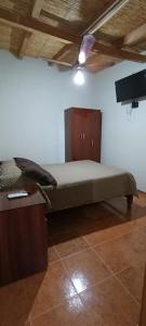 a large bed in a room with a wooden ceiling at Cabañas Casa de colores in Maimará