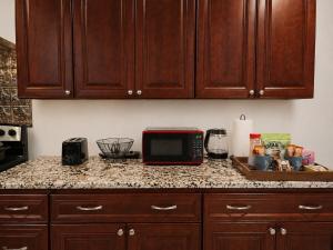 a kitchen with a counter top with a microwave at Spacious Studio by the Woods in Laurel +8 photos