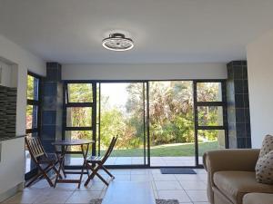a living room with a couch and a table at The Tee Box in Southbroom