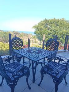 a blue table and chairs sitting on a patio at The Tee Box in Southbroom