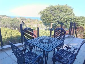 a blue table and chairs sitting on a porch at The Tee Box in Southbroom