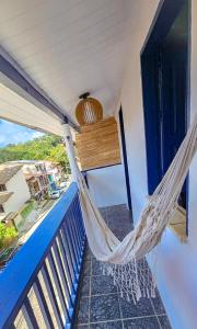 a hammock on the porch of a house at Pousada Mar de Itacaré in Itacaré