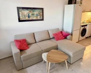 a living room with a couch and a table at Endless Blue Maisonette in Agios Ioannis Pelio