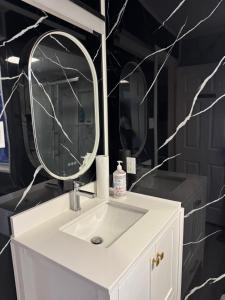 a bathroom with a white sink and a mirror at Mac B&B in Ottawa +17 photos