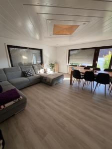 a living room with a couch and a table at Tannennest in Seewald