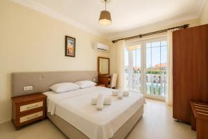 a bedroom with a bed and a large window at Larimar Suite Hotel in Oludeniz +153 photos