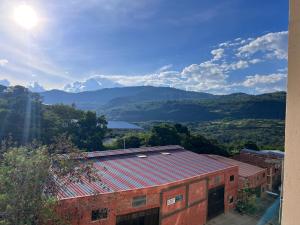 a red brick building with mountains in the background at Refugio Tenerife San Gil in San Gil +6 photos