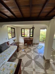 a living room with a couch and a table at Casa de Marina in Palmeiras