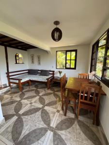 a living room with a table and a couch at Casa de Marina in Palmeiras +21 photos