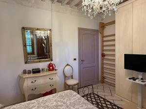 a bedroom with a bed and a mirror and a chair at 27 Arte Bientina in Bientina