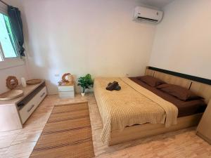 a bedroom with a bed and a sink in it at Serenity House with Large terrace in Ban Nok
