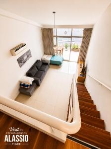 a living room with a couch and a staircase at Departamento Alassio in Tigre +111 photos
