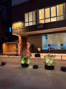 a hotel building with plants in front of it at Todo Luxury Suites in Durrës