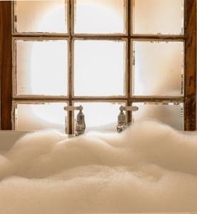 a bath tub sitting in front of a window at La Melosa Cottage in Cudillero +75 photos