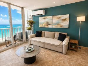 a living room with a couch and a table at Beachfront Stella Maris Apt on Condado Ave in San Juan