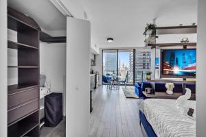 a bedroom with a bed and a living room with a tv at The Sanctuary King studio in Miami