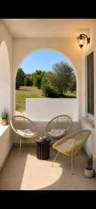 two chairs and a table on a patio at Villa Olivia in Banjole