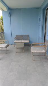 two beds sitting on a porch with a blue wall at Maya Dream in Morne Blanc +3 photos