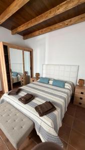 a bedroom with a large bed with blue pillows at Apartamentos Violante in Tuineje
