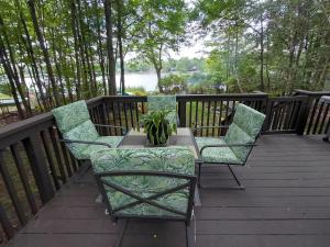 a patio with two chairs and a table on a deck at LAKEFRONT CHALET in THE BURCHES in Tobyhanna