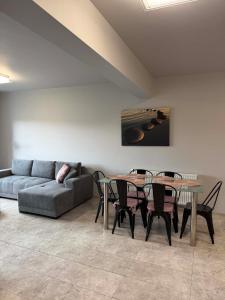 a living room with a couch and a table and chairs at City Centre Balcony Apartments in Wadowice