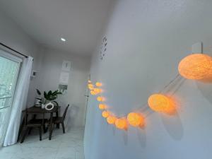 a room with a table and orange lights on the wall at Diamond House in Srithanu in Srithanu