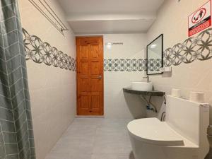 a bathroom with a toilet and a sink at Rihiveli Residence Thoddoo in Thoddoo +64 photos