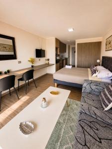 a hotel room with a bed and a living room at Centro Vista Al Mar san Martin Coliving in Antofagasta