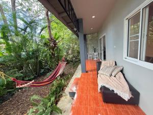 a porch with a hammock on a house at Diamond House in Srithanu in Srithanu