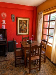 a dining room with a wooden table and chairs at Hostal sabana Tilcara in Tilcara
