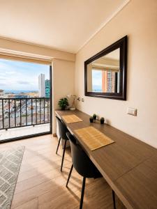 a dining room with a table and a large window at Centro Vista Al Mar san Martin Coliving in Antofagasta