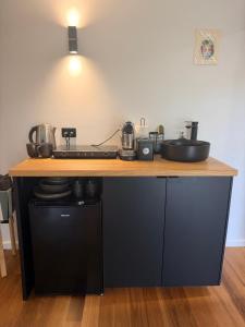 a kitchen with a counter with a sink and a stove at Mustang Studios in Canberra