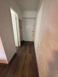 an empty room with a door and a wooden floor at Martin House Motel in Brookfield